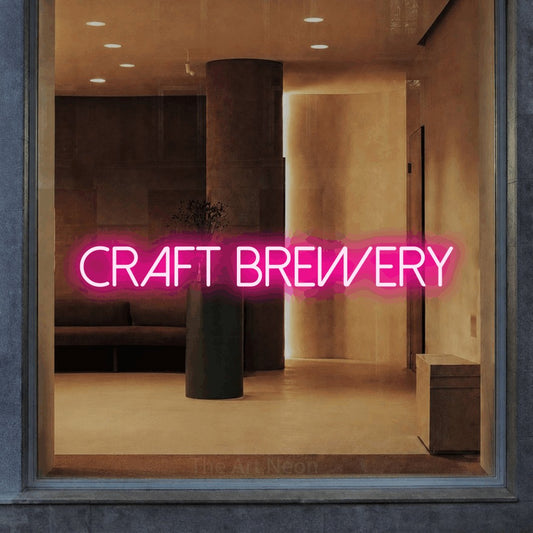 Hot pink LED neon sign reading "Craft Brewery" in a warm modern interior