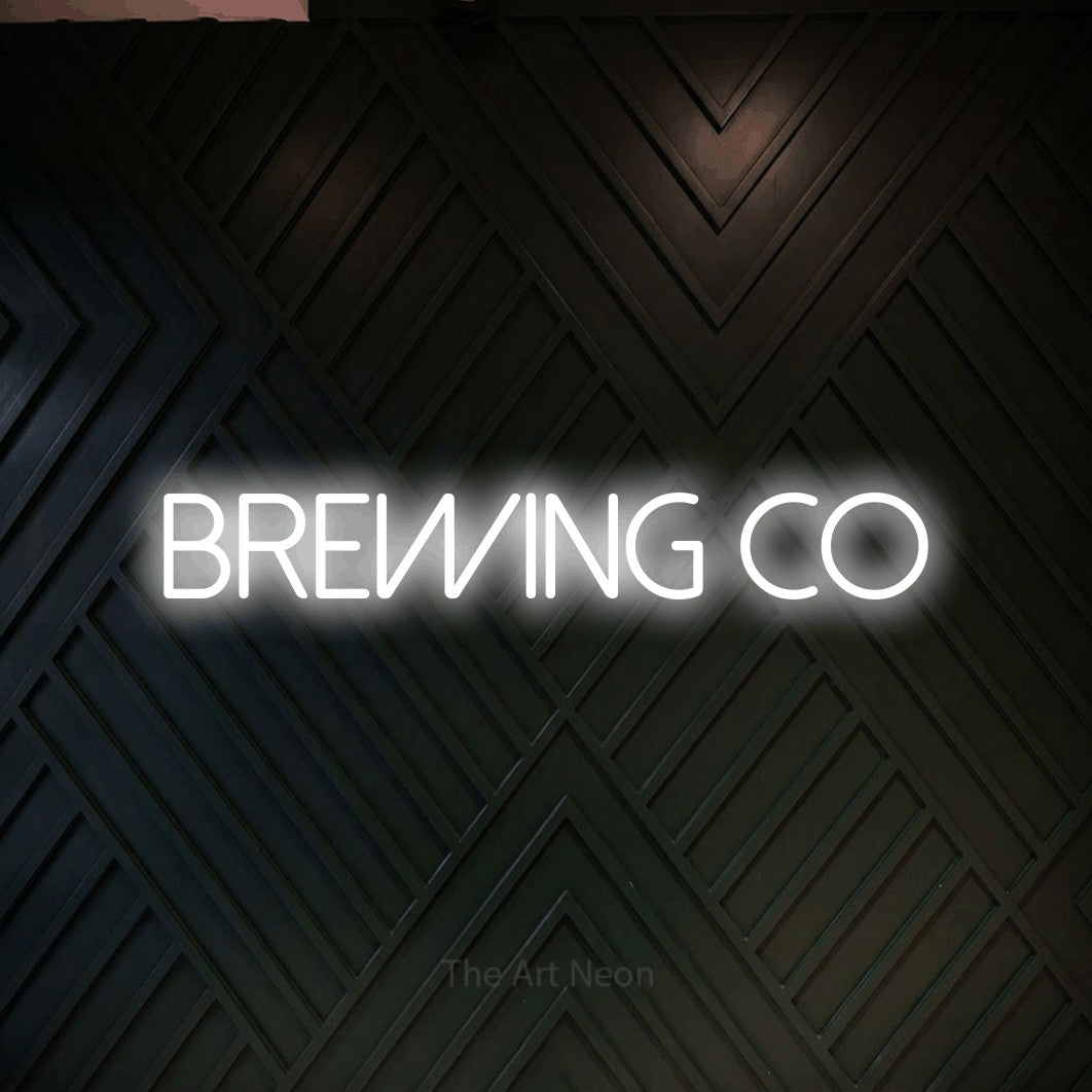 Cool white LED neon sign reading "Brewing Co" against a dark geometric wood wall