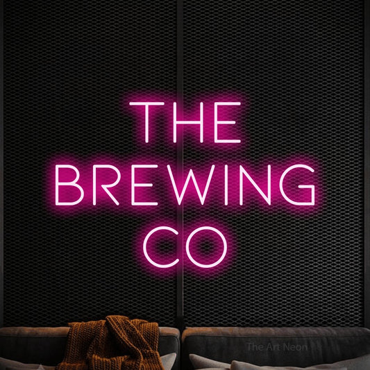 Hot pink LED neon sign reading "The Brewing Co" against a black textured wall