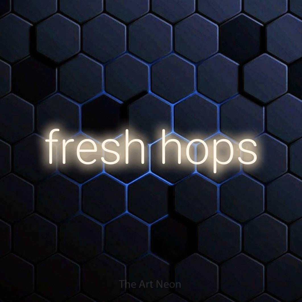 Warm white LED neon sign reading "Fresh Hops" against a blue hexagonal wall