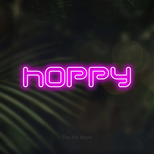 Pink outline-style LED neon sign reading "Hoppy" against dark blurred palm leaves