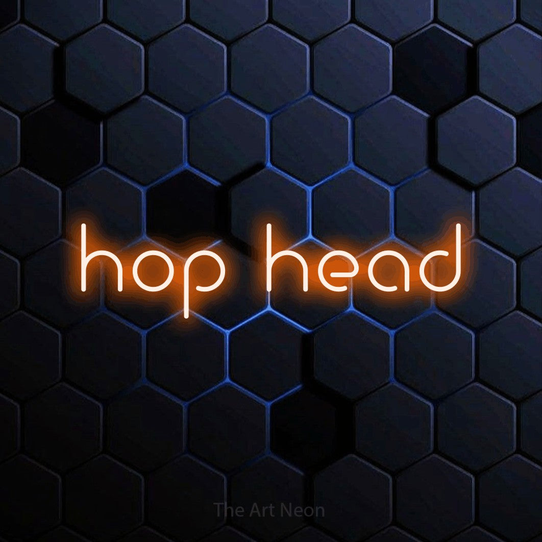 Orange LED neon sign reading "Hop Head" against a blue hexagonal wall