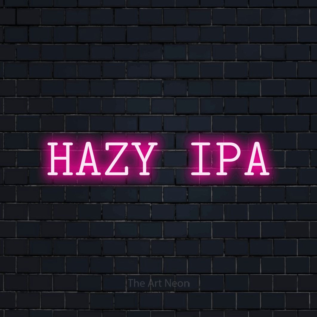 Hot pink LED neon sign reading "Hazy IPA" against a dark navy brick wall