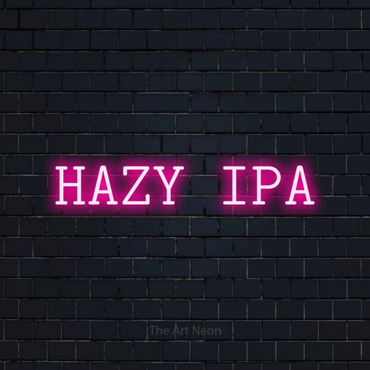 Hot pink LED neon sign reading "Hazy IPA" against a dark navy brick wall