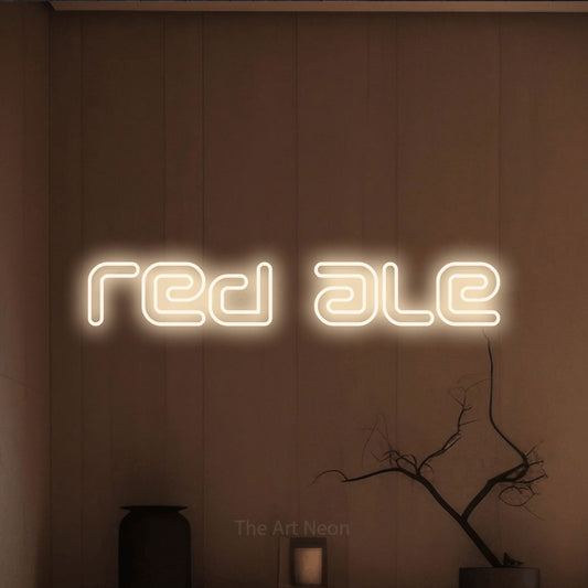Warm white outline-style LED neon sign reading "Red Ale" against a warm brown wall