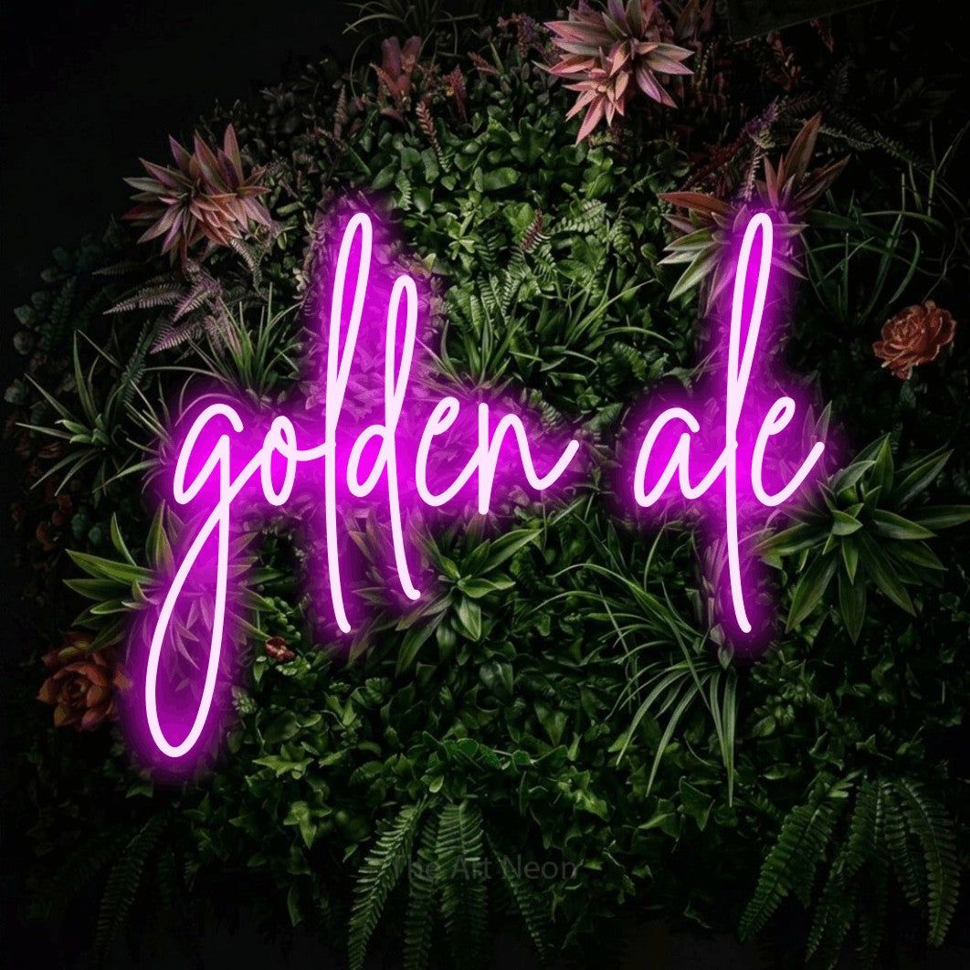 Pink script-style LED neon sign reading "Golden Ale" against a flowering garden wall