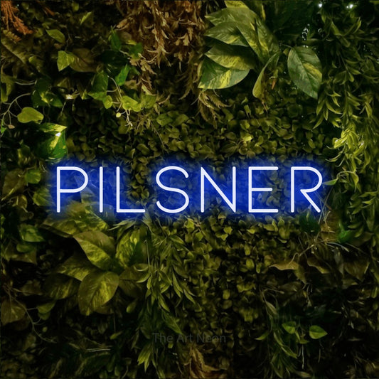 Blue LED neon sign reading "Pilsner" against a textured moss and foliage wall