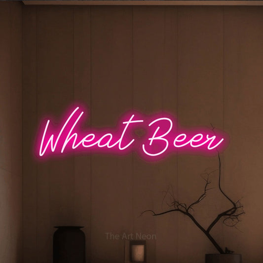 Hot pink script-style LED neon sign reading "Wheat Beer" against a warm brown wall