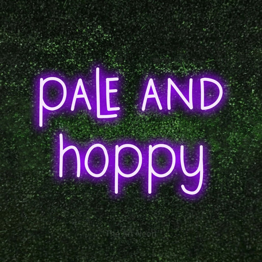 Purple LED neon sign reading "Pale and Hoppy" against a textured green moss wall