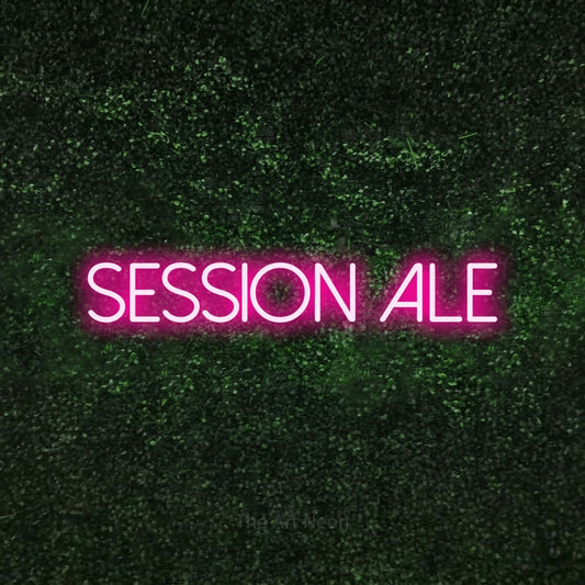 Hot pink LED neon sign reading "Session Ale" against a textured green moss wall