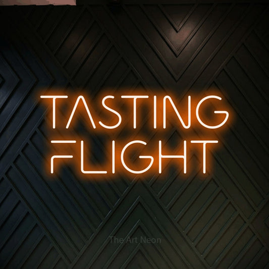 Orange LED neon sign reading "Tasting Flight" against a dark geometric wood wall