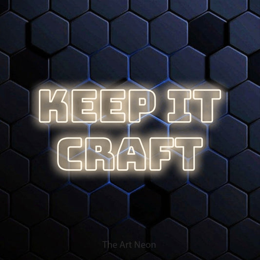 Warm white outline-style LED neon sign reading "Keep It Craft" against a blue hexagonal wall