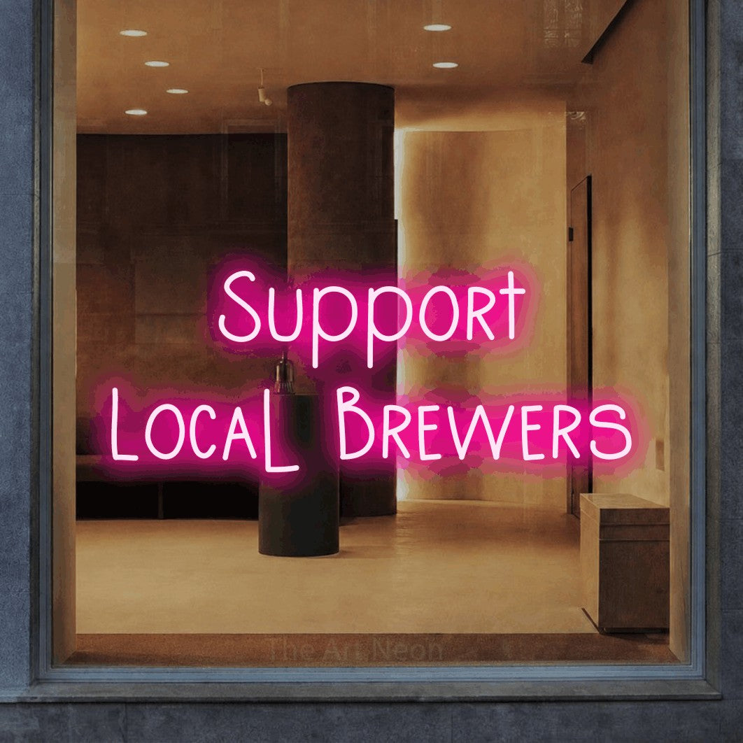 Hot pink LED neon sign reading "Support Local Brewers" in a warm modern interior
