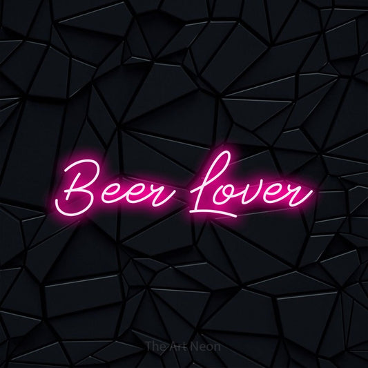 Hot pink script-style LED neon sign reading "Beer Lover" against a black faceted wall