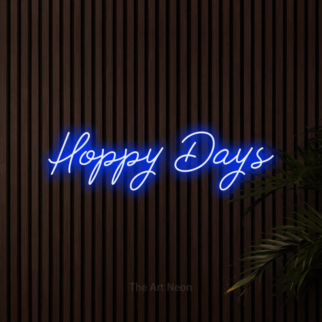 Blue script-style LED neon sign reading "Hoppy Days" against dark wooden slats