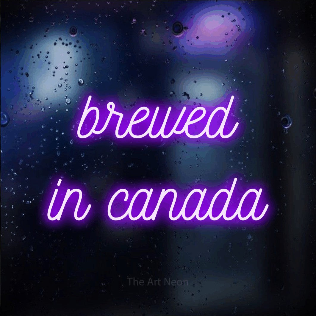 Purple script-style LED neon sign reading "Brewed in Canada" against a dark blue bokeh background