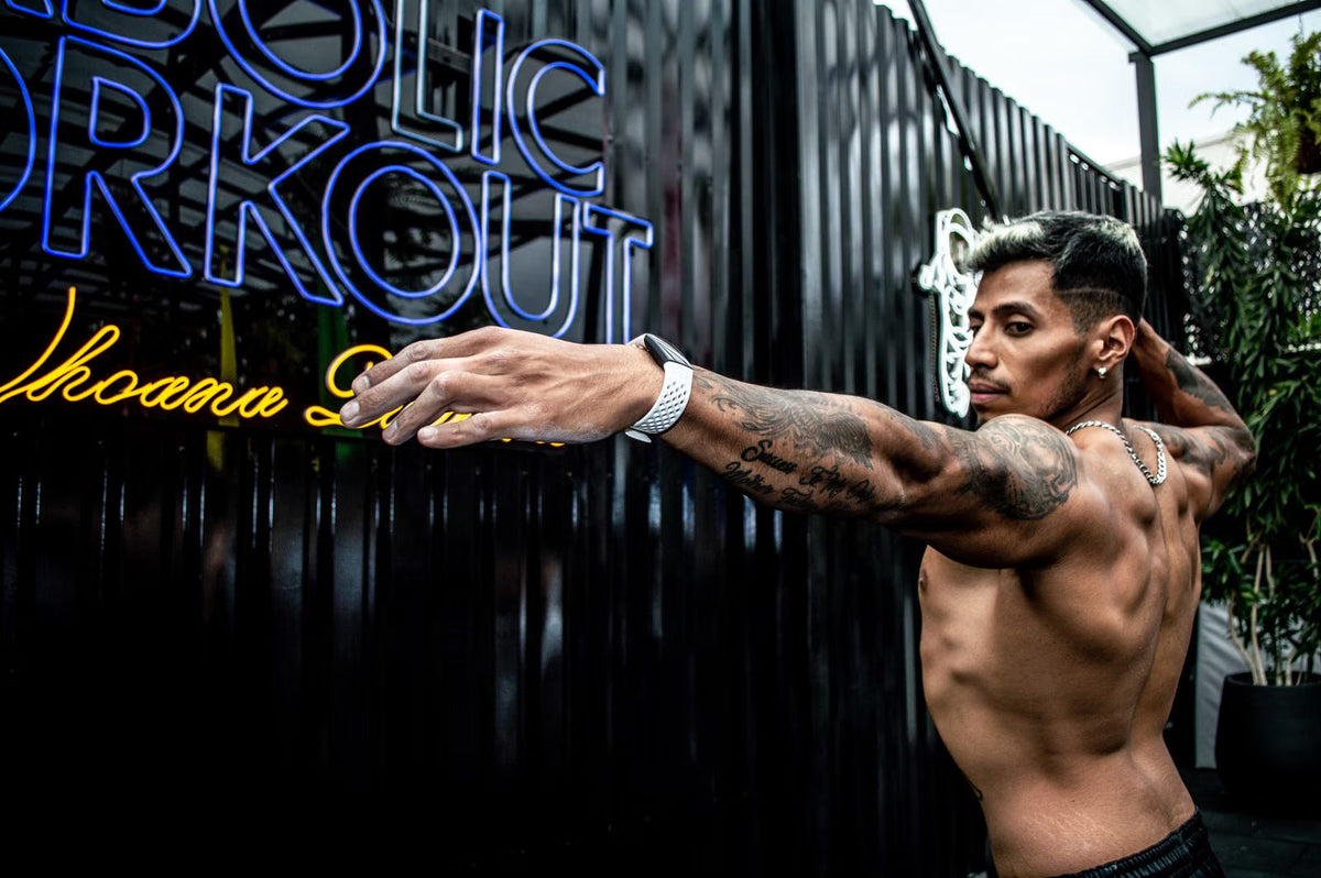 Athlete beside a blue LED neon sign in a modern gym setting