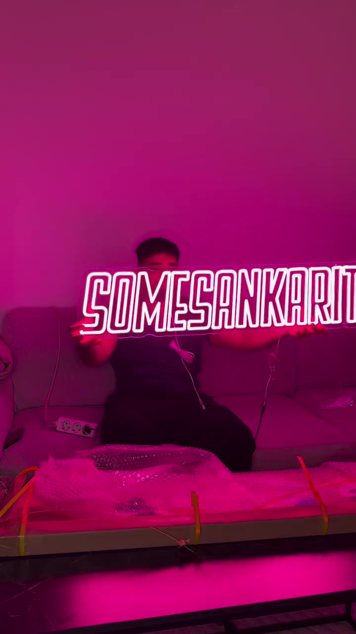 Custom Somesankarit name LED neon being unboxed and installed in the creators’ space.