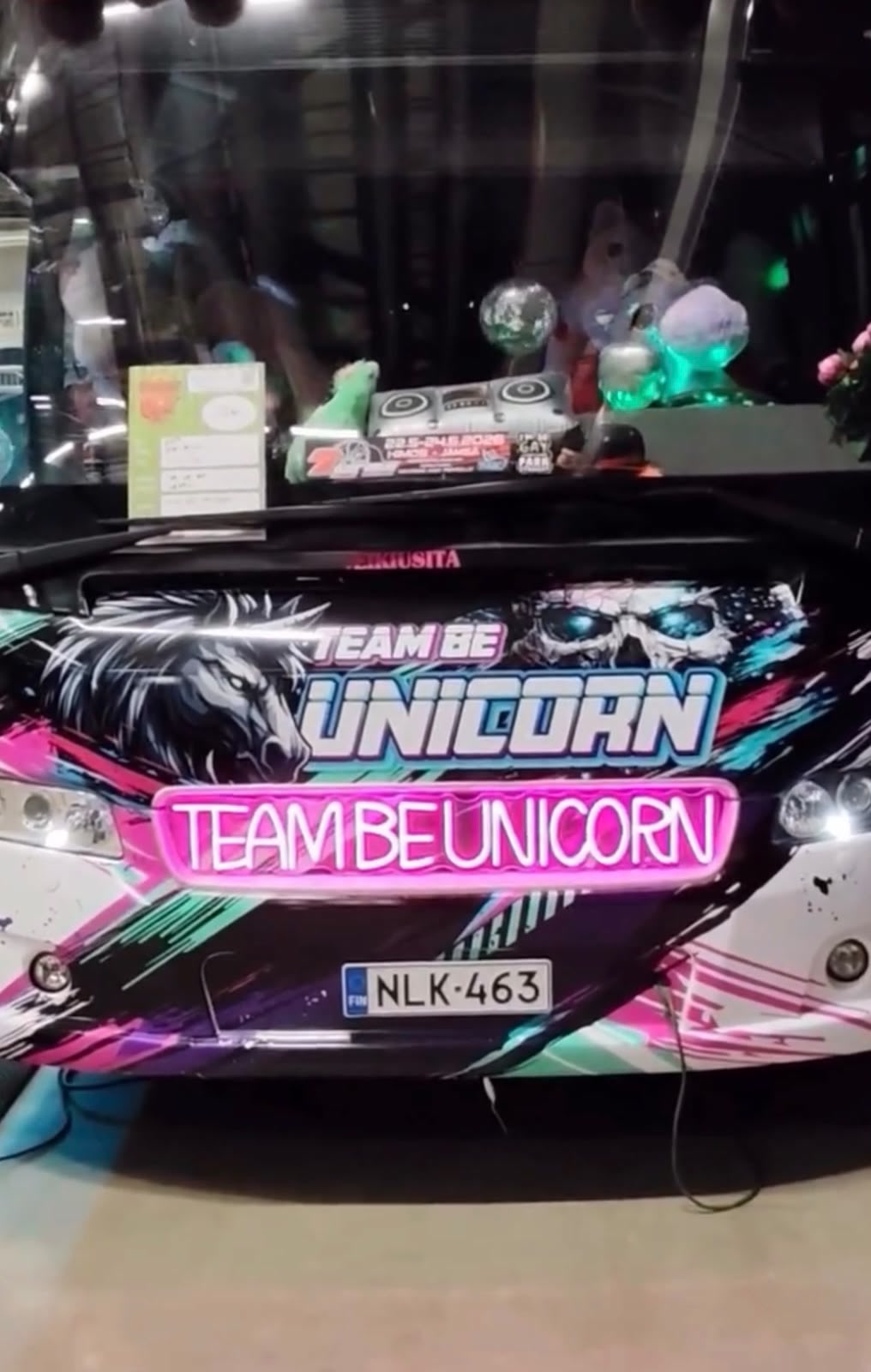 Pink Team Be Unicorn LED neon displayed with the team’s colourful custom show bus.