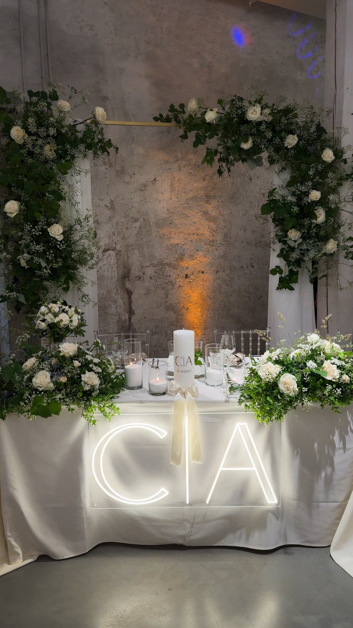 Warm-white C and A initials LED neon displayed on a table for a wedding celebration.