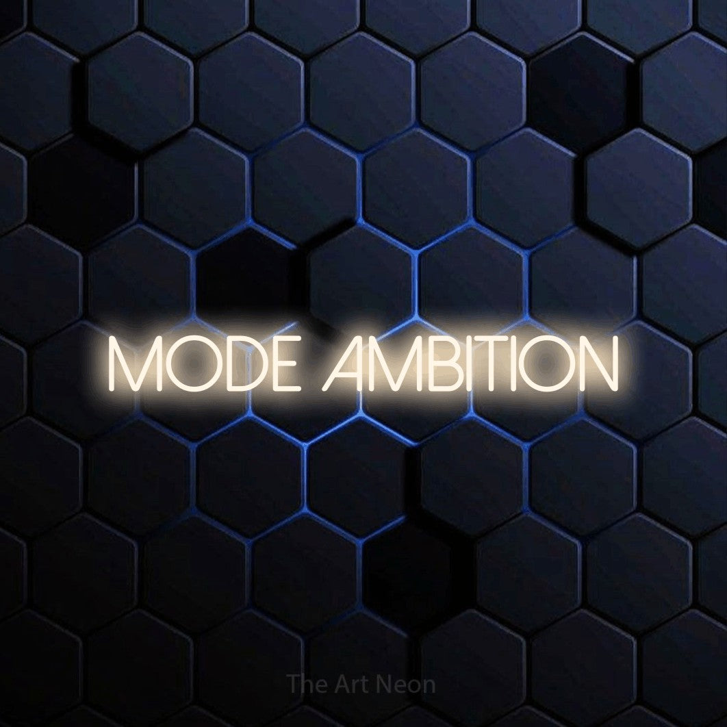 “Mode ambition” LED neon sign in warm white, with thin sans-serif lettering, shown against a dark blue honeycomb pattern.