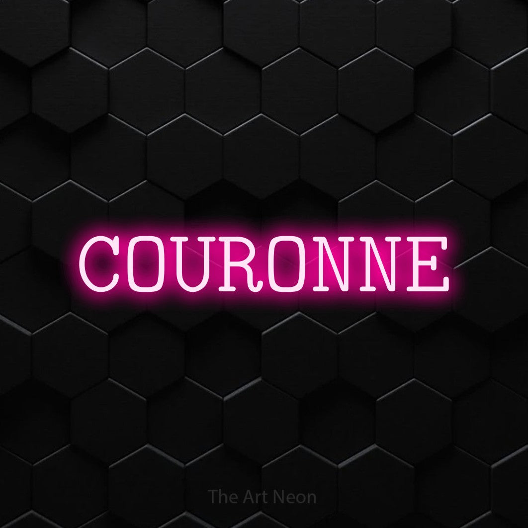 “Couronne” LED neon sign in hot pink, with typewriter-style lettering, shown against black hexagonal wall tiles.