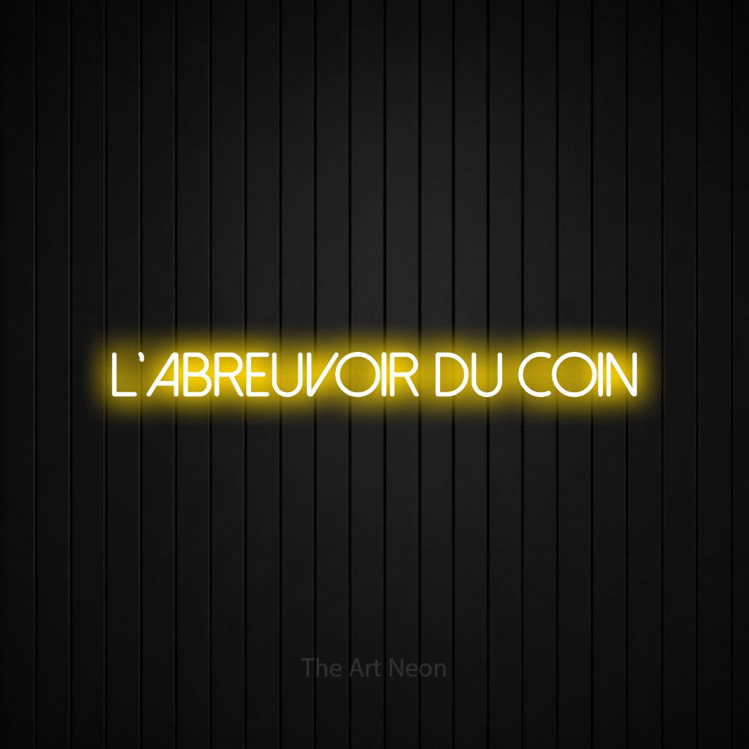 “L'abreuvoir du coin” LED neon sign in yellow, with thin sans-serif lettering, shown against black vertical wall slats.