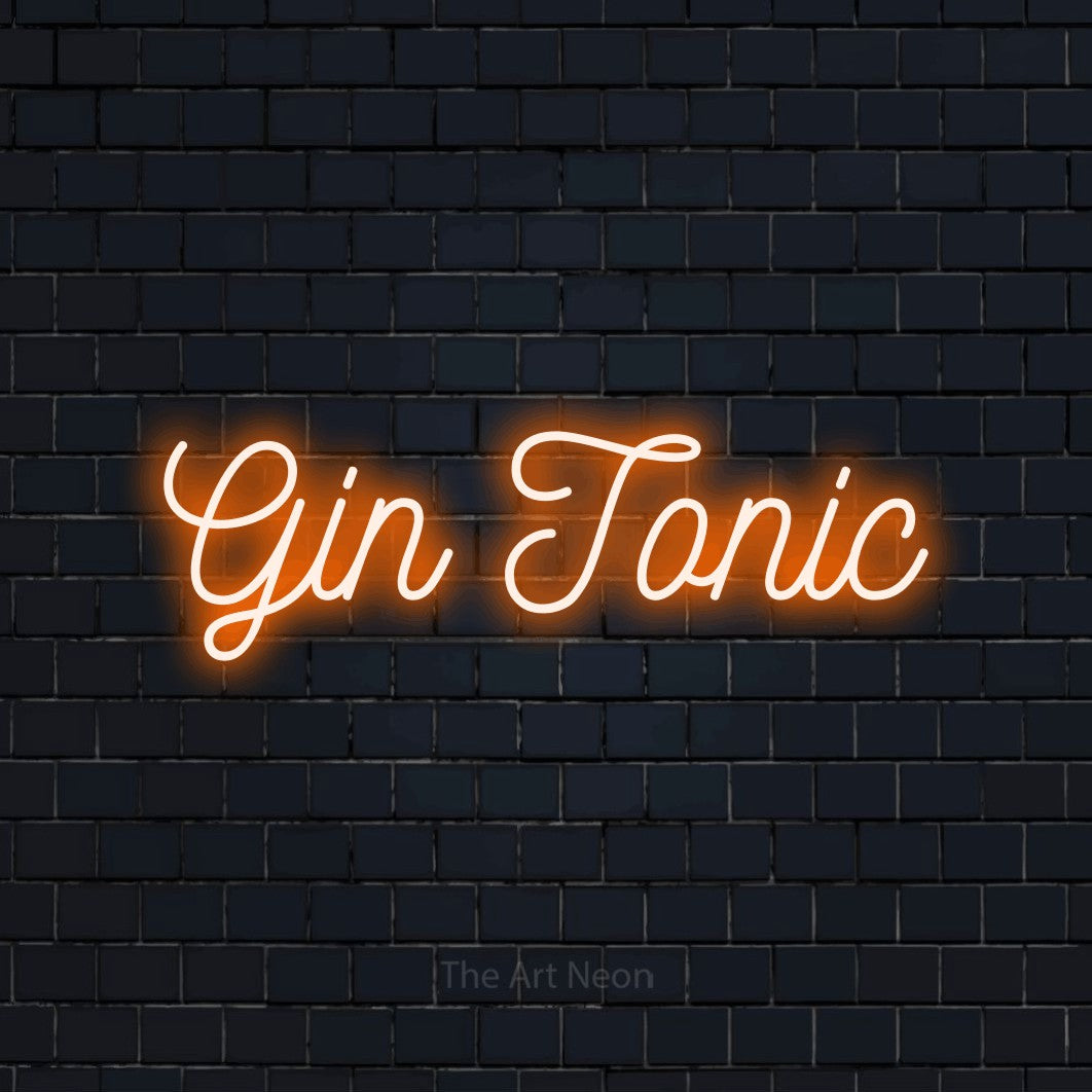 “Gin tonic” LED neon sign in orange, with ornate cursive lettering, shown against a dark navy brick wall.