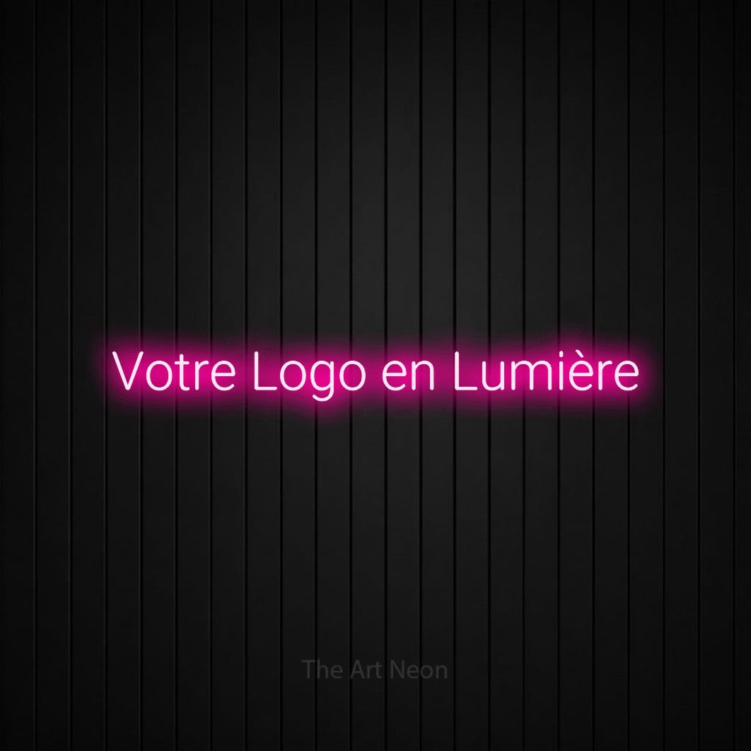“Votre logo en lumière” LED neon sign in hot pink, with rounded sans-serif lettering, shown against black vertical wall slats.
