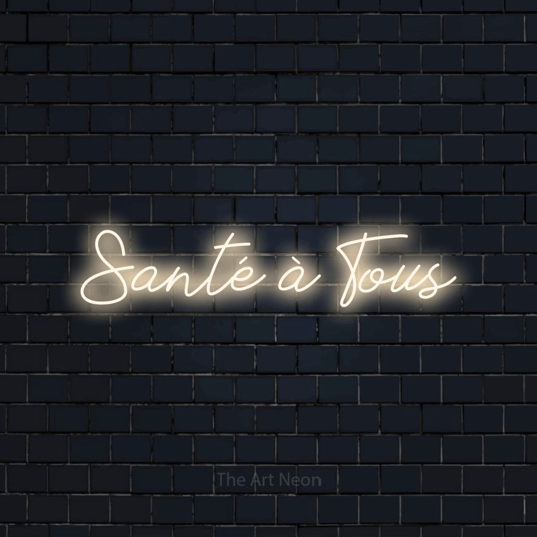 Lettrage en néon LED « Santé à tous » en blanc chaud, en lettrage cursif, présenté sur un mur de briques bleu marine foncé, pour un bar à la maison.