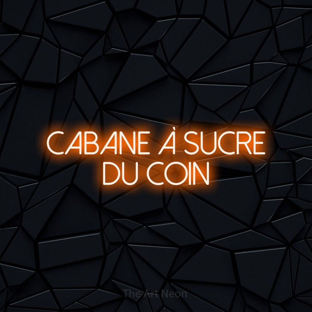 “Cabane à sucre du coin” LED neon sign in orange, with thin sans-serif lettering across 2 lines, shown against a black polygonal surface.