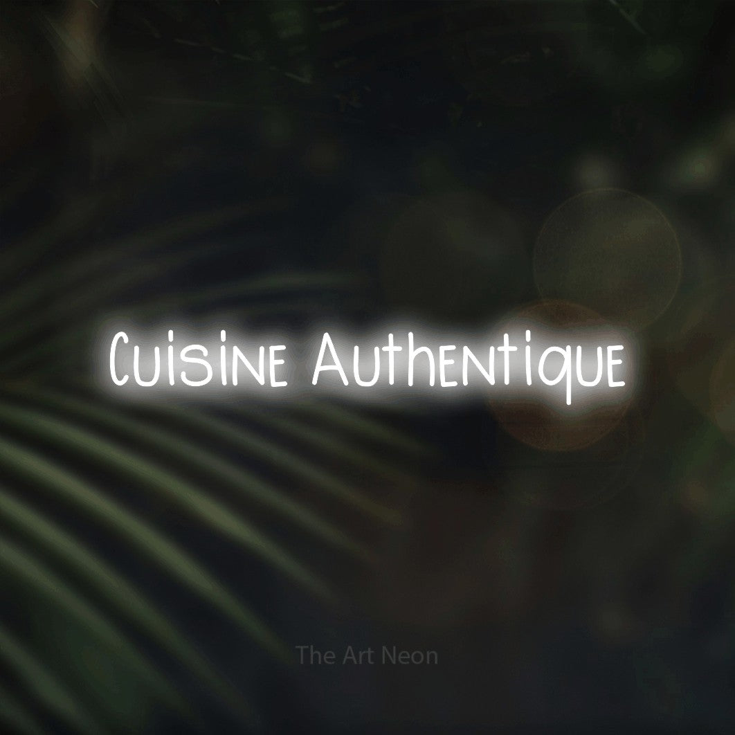 “Cuisine authentique” LED neon sign in cool white, with narrow hand-drawn lettering, shown against a blurred palm and bokeh-light backdrop.