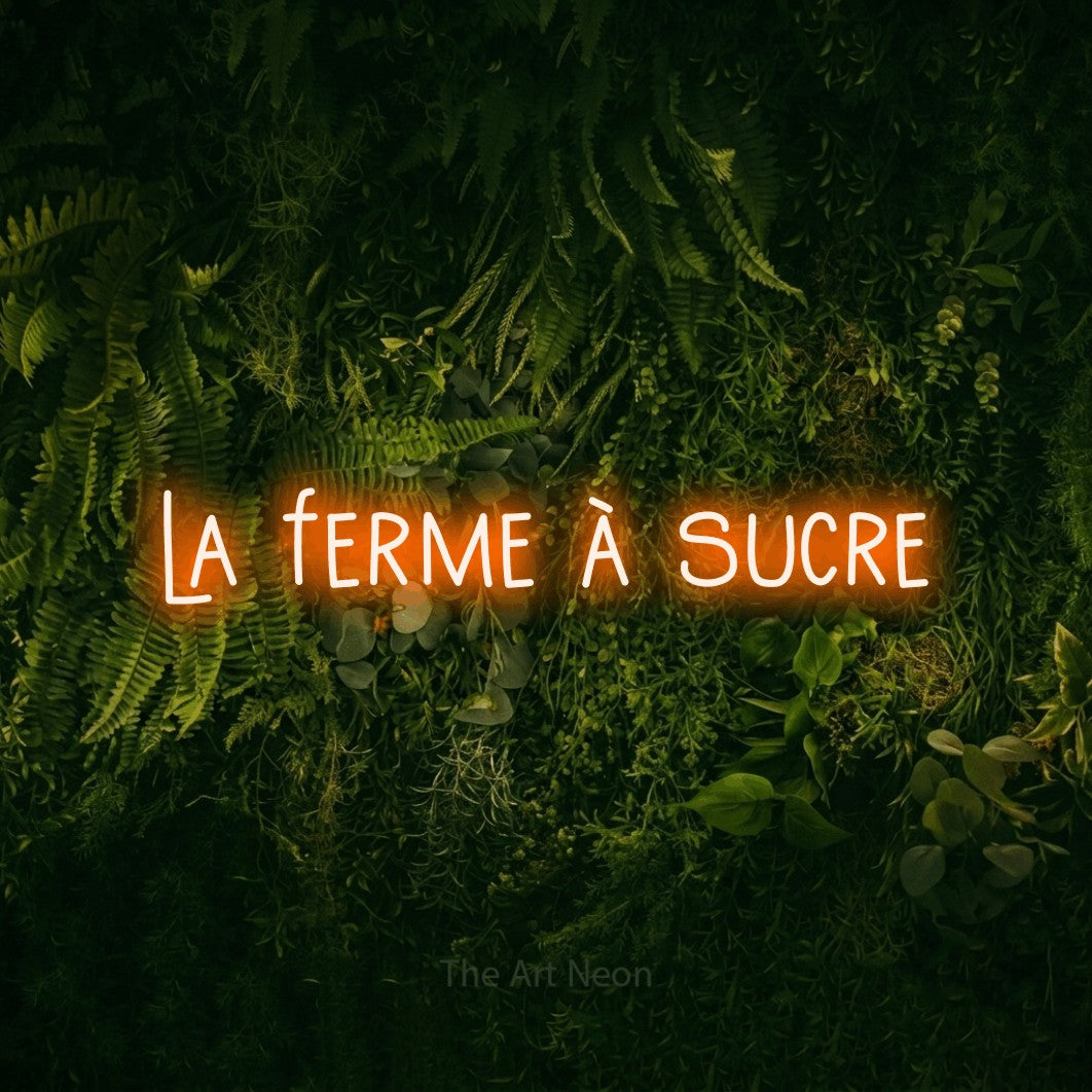 “La ferme à sucre” LED neon sign in orange, with narrow hand-drawn lettering, shown against a dark moss and forest backdrop.