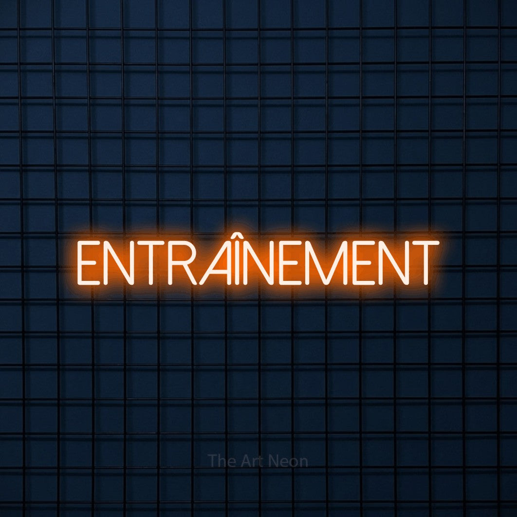 “Entraînement” LED neon sign in orange, with thin sans-serif lettering, shown against a dark blue grid.