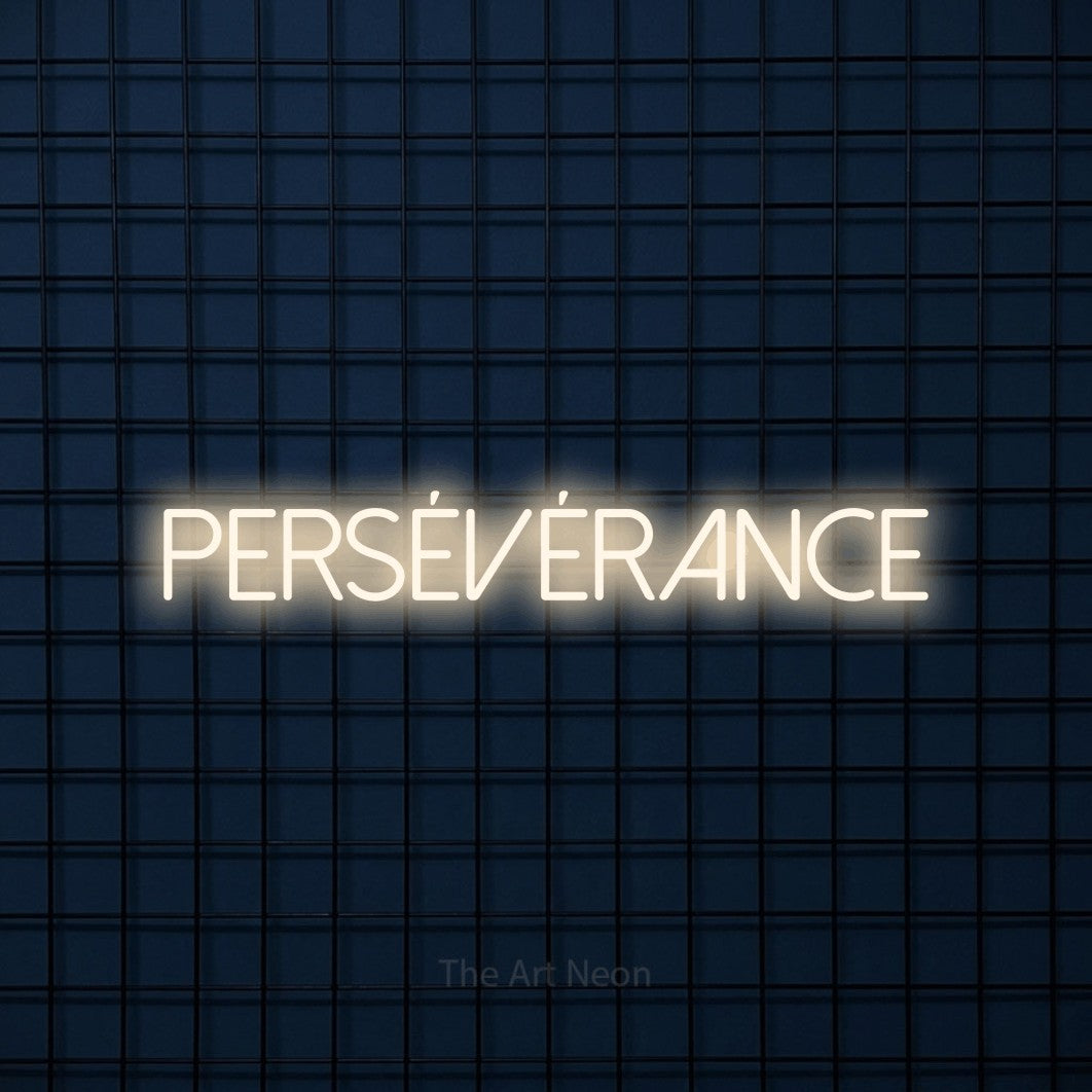 “Persévérance” LED neon sign in warm white, with thin sans-serif lettering, shown against a dark blue grid.