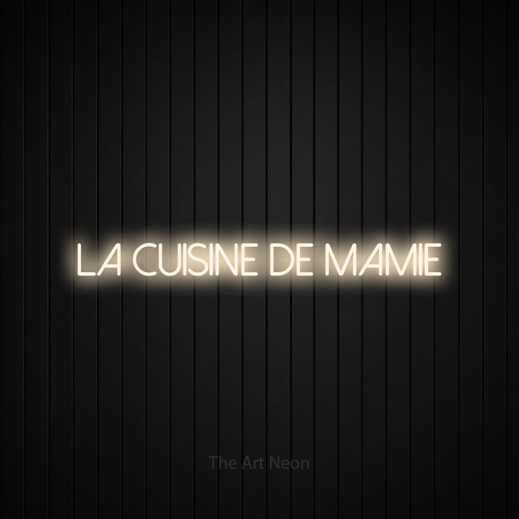 “La cuisine de mamie” LED neon sign in warm white, with thin sans-serif lettering, shown against black vertical wall slats.