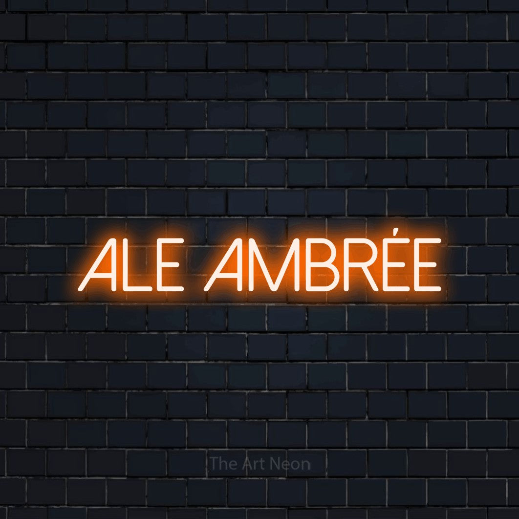 “Ale ambrée” LED neon sign in orange, with thin sans-serif lettering, shown against a dark navy brick wall.