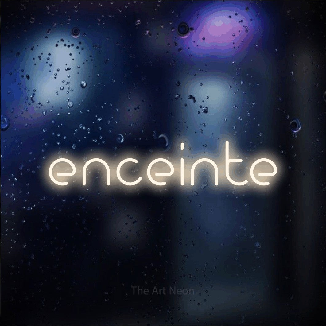 “Enceinte” LED neon sign in warm white, with stylised geometric lettering, shown against glass with blue and purple reflections.