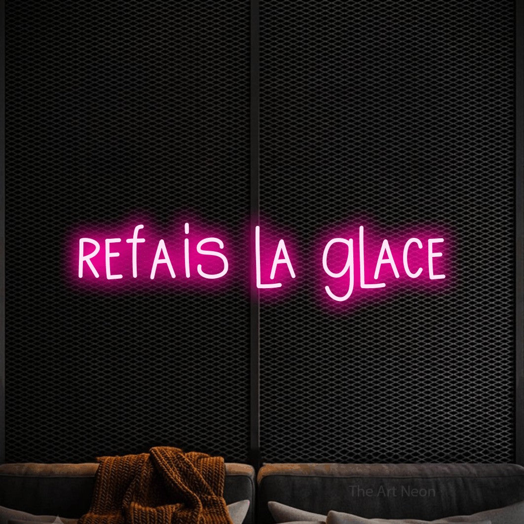 “Refais la glace” LED neon sign in hot pink, with narrow hand-drawn lettering, shown against a modern dark-toned seating area.