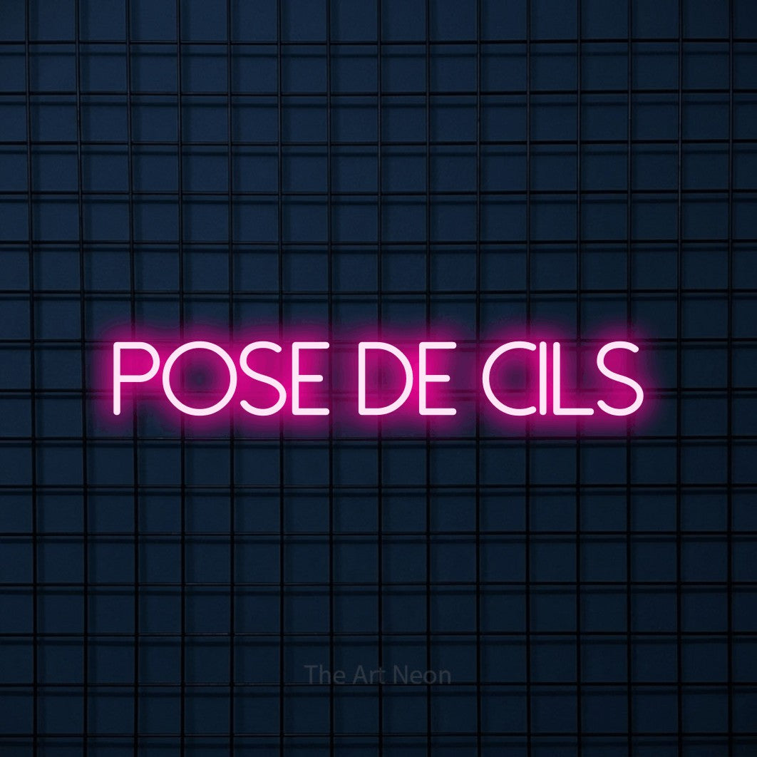 “Pose de cils” LED neon sign in hot pink, with thin sans-serif lettering, shown against a dark blue grid.