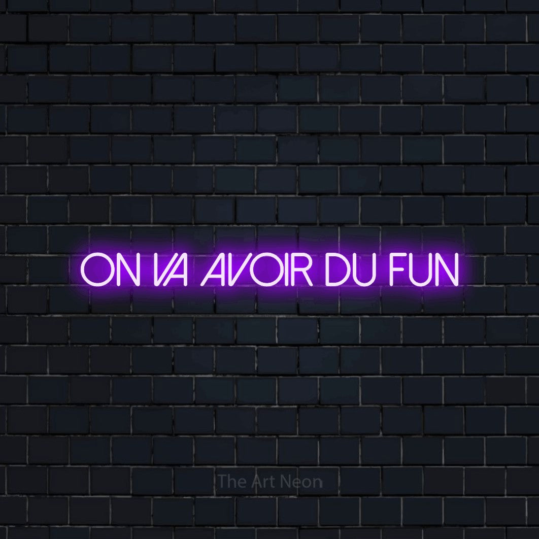 “On va avoir du fun” LED neon sign in purple, with thin sans-serif lettering, shown against a dark navy brick wall.