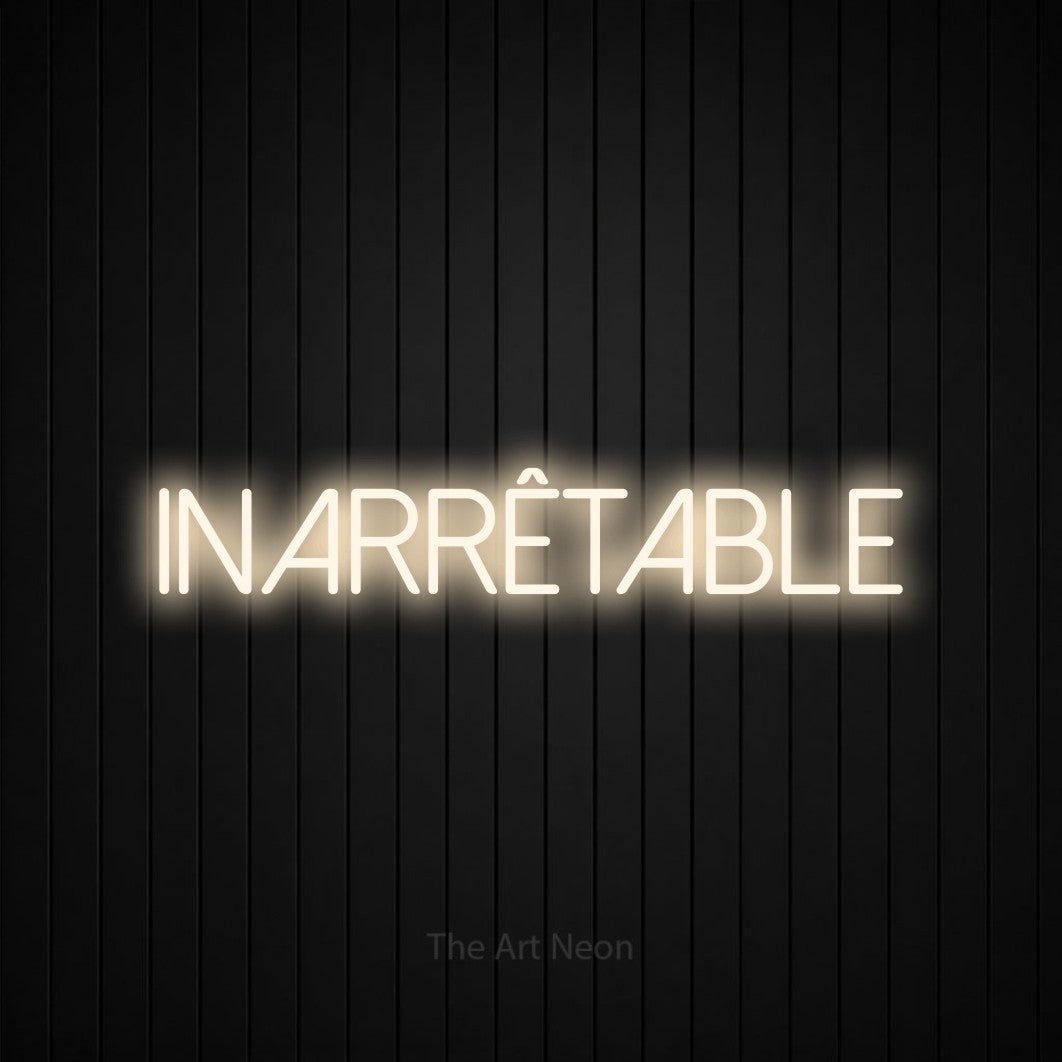 “Inarrêtable” LED neon sign in warm white, with thin sans-serif lettering, shown against black vertical wall slats.