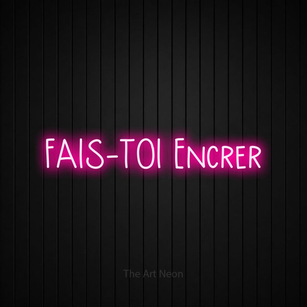 “Fais-toi encrer” LED neon sign in hot pink, with narrow hand-drawn lettering, shown against black vertical wall slats.