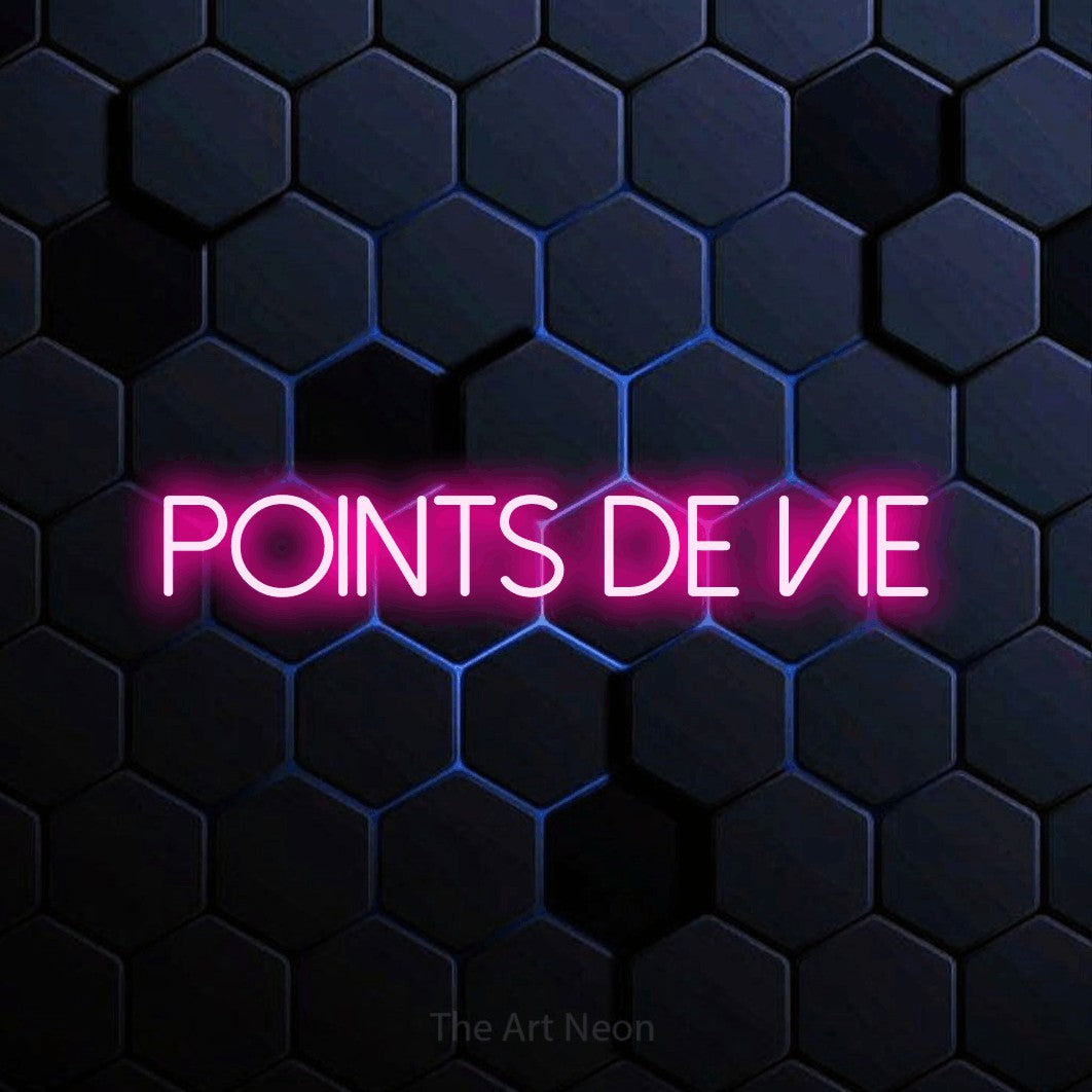 “Points de vie” LED neon sign in hot pink, with thin sans-serif lettering, shown against a dark blue honeycomb pattern.