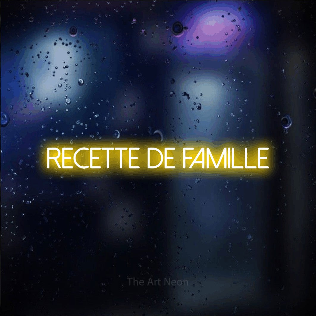“Recette de famille” LED neon sign in yellow, with thin sans-serif lettering, shown against glass with blue and purple reflections.