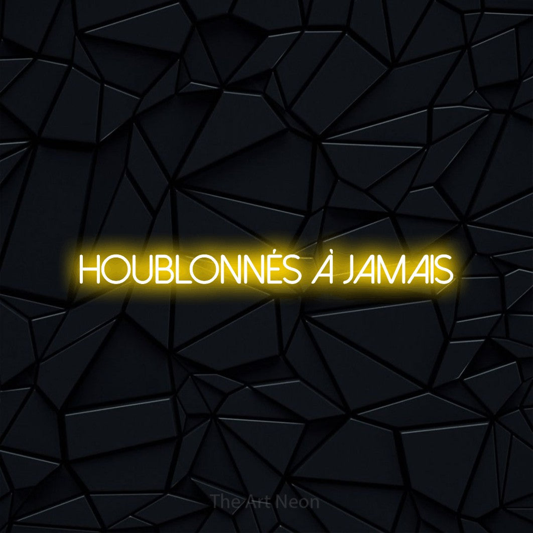 “Houblonnés à jamais” LED neon sign in yellow, with thin sans-serif lettering, shown against a black polygonal surface.