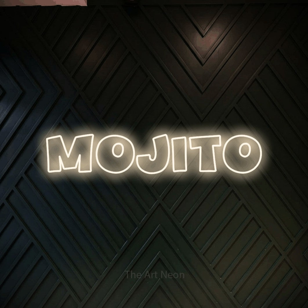“Mojito” LED neon sign in warm white, with wide lettering with irregular outlines, shown against a black chevron-patterned wood wall.