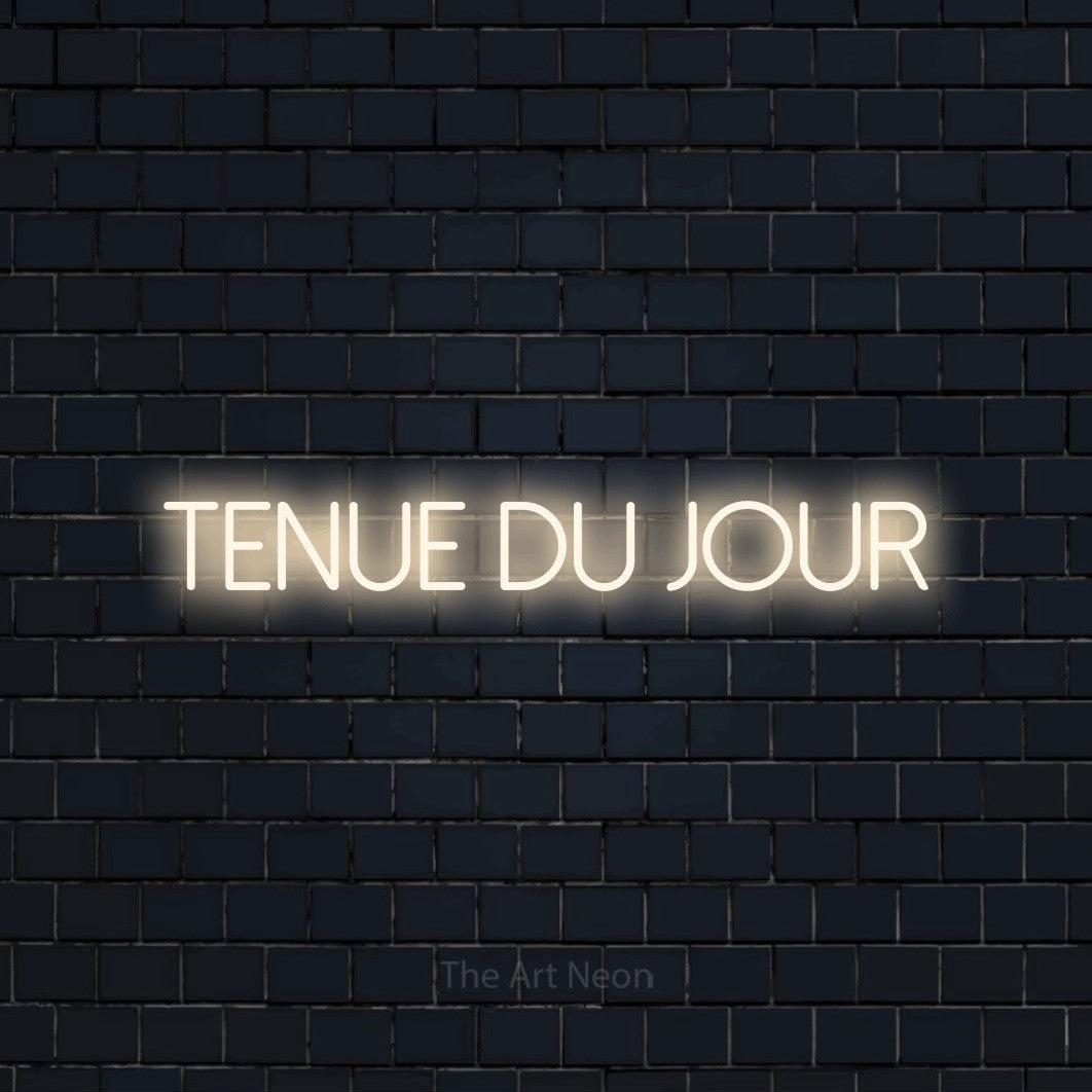 “Tenue du jour” LED neon sign in warm white, with thin sans-serif lettering, shown against a dark navy brick wall.