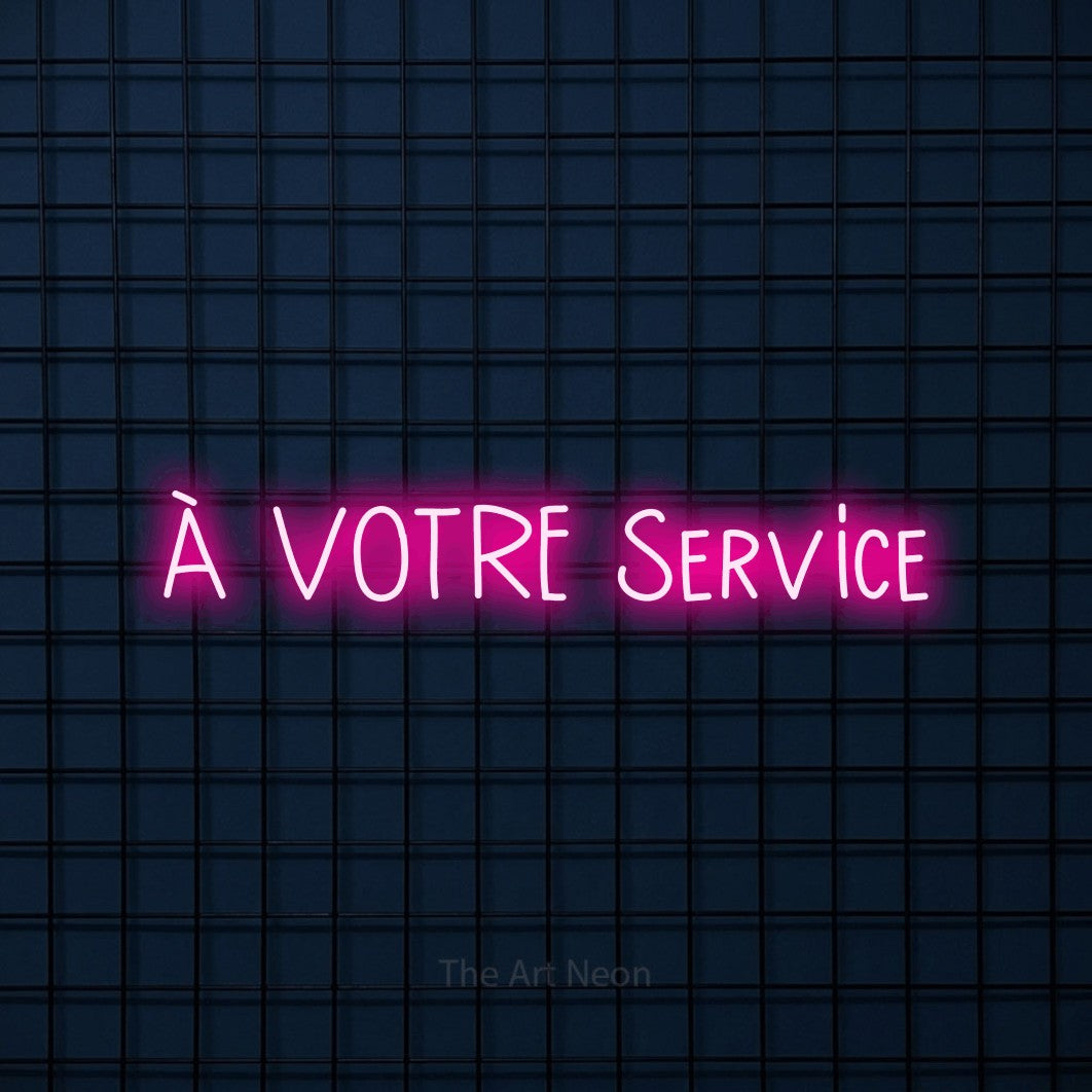 “À votre service” LED neon sign in hot pink, with narrow hand-drawn lettering, shown against a dark blue grid.