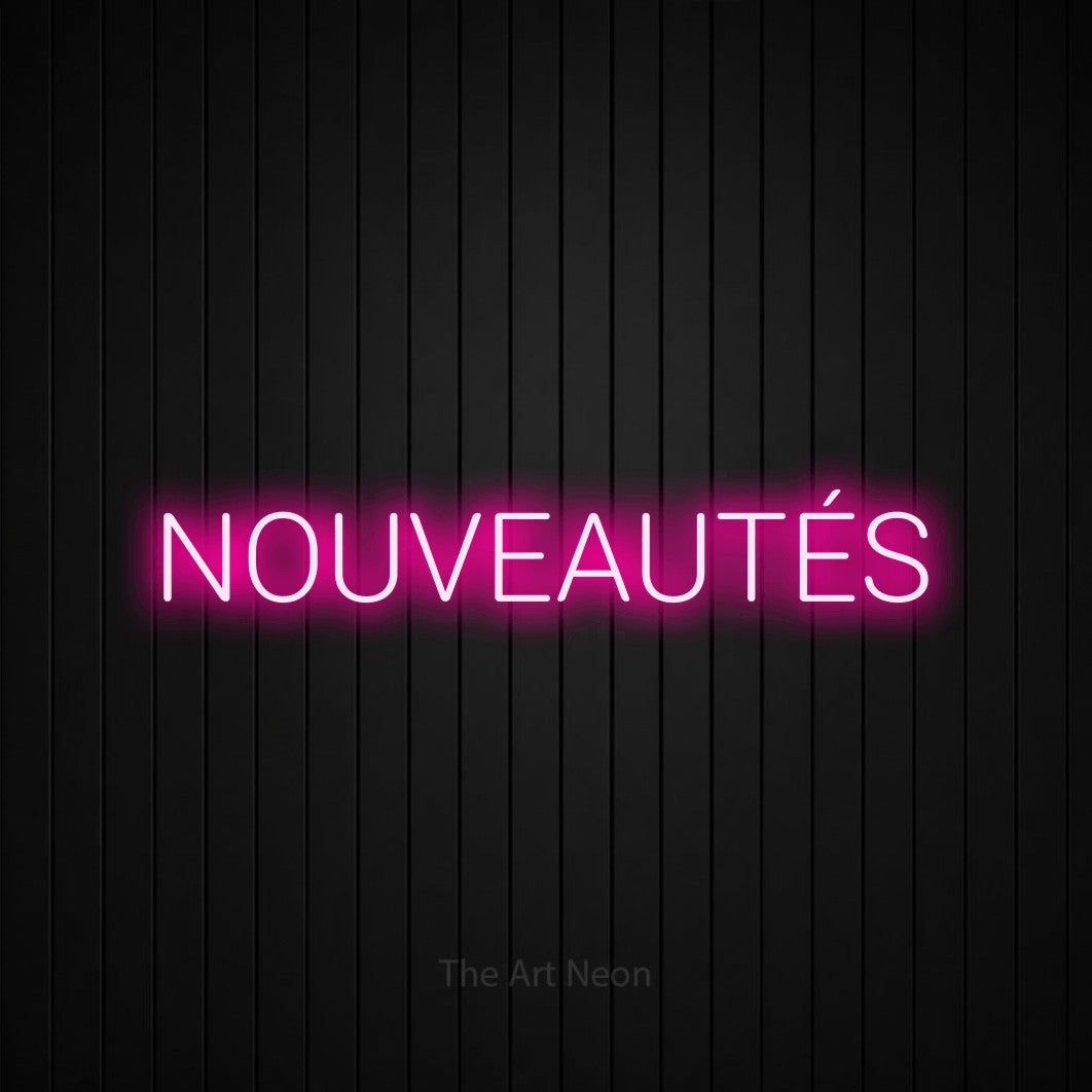 “Nouveautés” LED neon sign in hot pink, with rounded sans-serif lettering, shown against black vertical wall slats.
